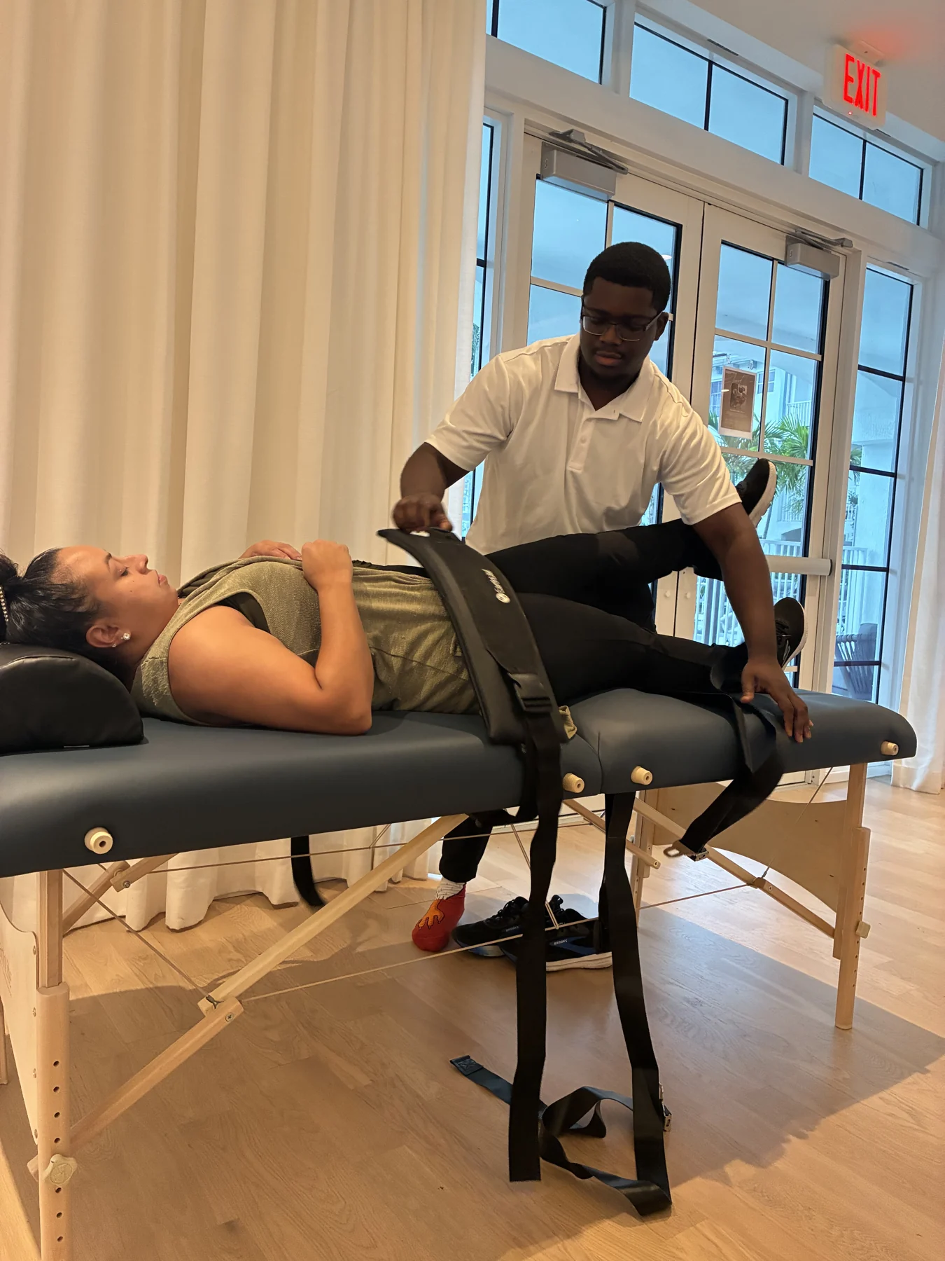 A participant receiving assisted stretching at a community event