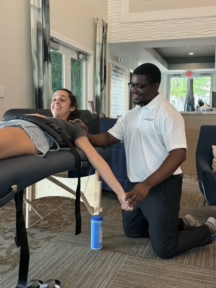 A smiling participant and practitioner during an event session