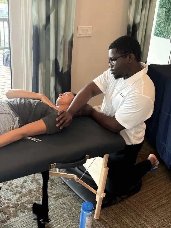 A participant receiving a shoulder stretch