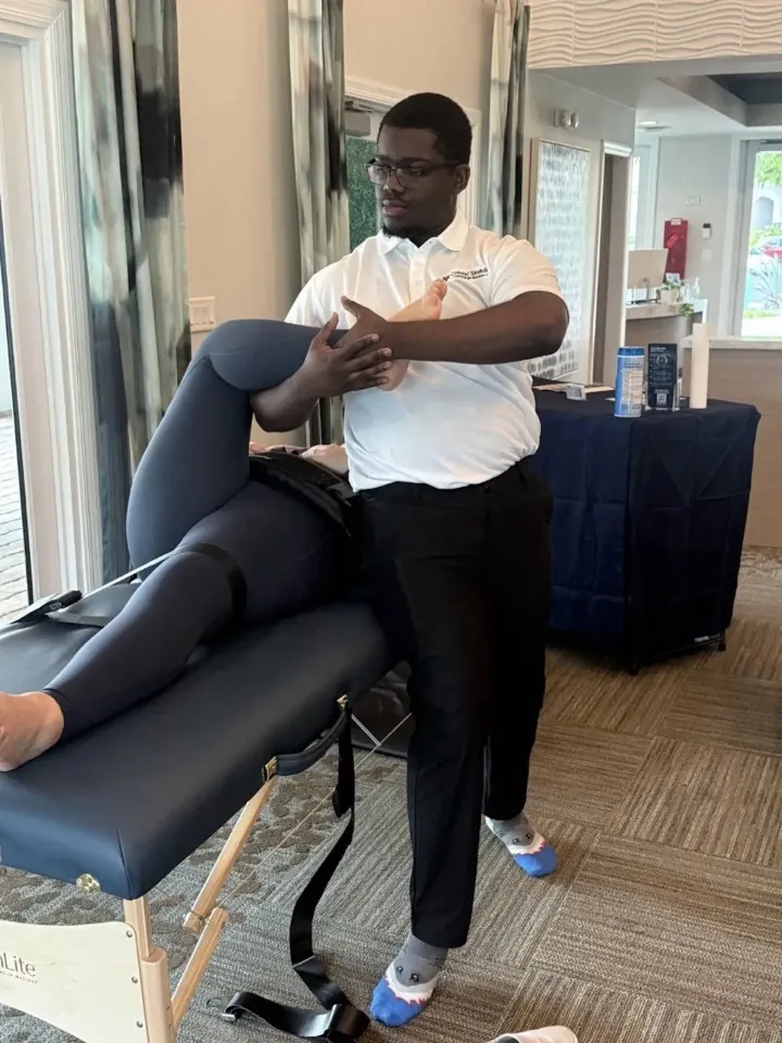 One-on-one assisted stretching beside the event table