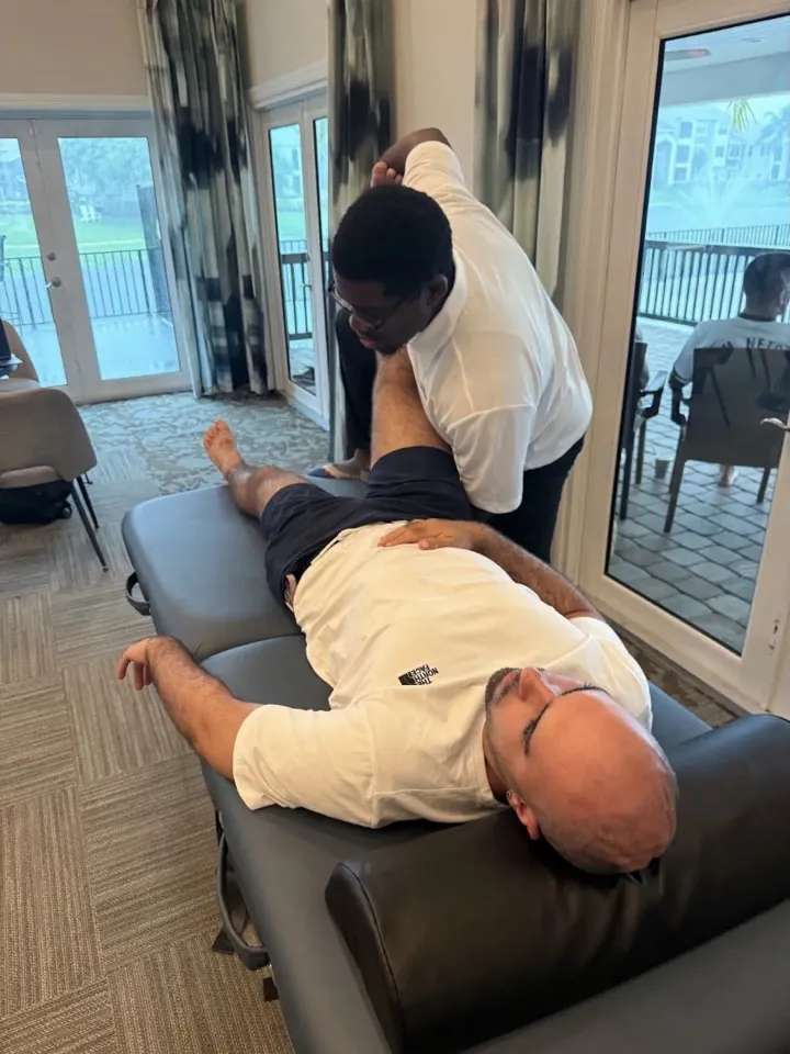 A hands-on stretch beside the room's large windows
