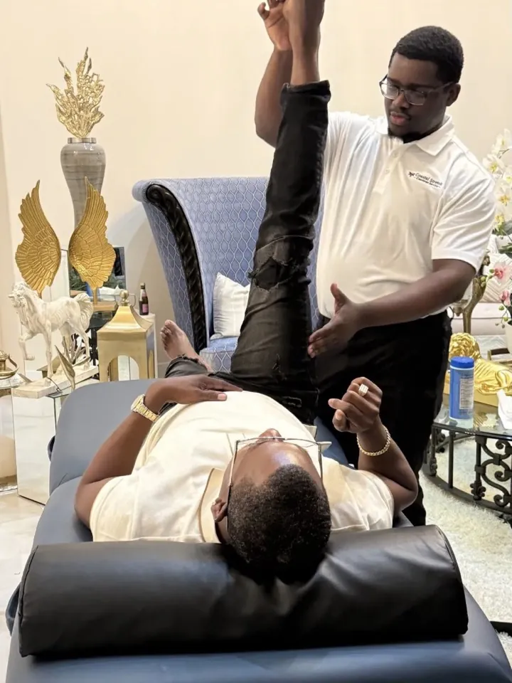 A participant’s raised leg guided through a stretch
